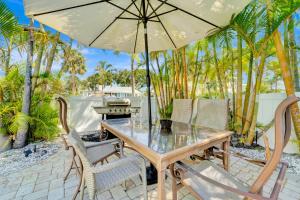 布雷登顿海滩Casa Del Sol B的庭院内桌椅和遮阳伞