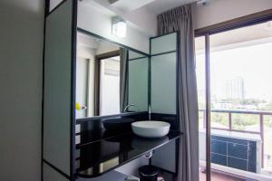 暖武里府Regent Ngamwongwan Hotel的一间带水槽和大镜子的浴室