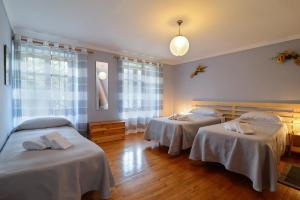 Villar PelliceBed & Breakfast Ai Fontana的一间设有两张床铺的房间,配有白色床单