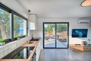 苏提万Holiday house Sunset Haven Estate的带大窗户的厨房,享有庭院的景致。