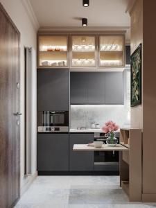 华沙Luxury Touch Apartment by ECRU WWA26的厨房配有灰色橱柜和鲜花桌