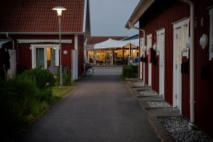 瓦尔贝里Apelviken Lägenhetshotell的两座红色建筑之间的小巷,旁边停着一辆自行车