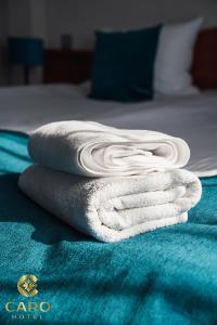 波兹南Hotel CARO的床上的一大堆毛巾