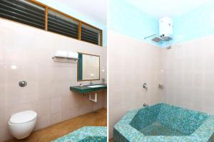 黎明之村Les Boganveillea Heritage Guest House的浴室配有卫生间、盥洗盆和浴缸。
