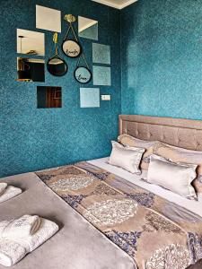 贝尔格莱德MOOW Apartments的一间卧室配有一张带蓝色墙壁的大床