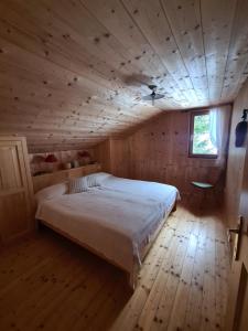 比尔塞贝格Burtscha Lodge im Sommer inklusive der Gästekarte Premium的木制客房内的一间卧室配有一张大床