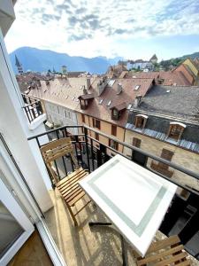 安锡T3 de 73 m2 , garage , vue montagnes et château的市景阳台配有椅子