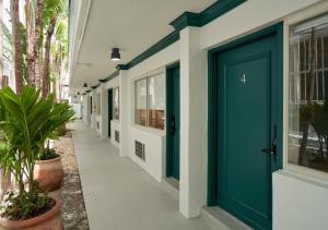 迈阿密海滩Aloha Fridays的大楼内带蓝色门的走廊