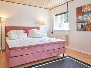 伦讷Holiday home Rønne VI的一间卧室,卧室内配有一张大型粉红色床