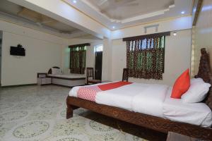 焦特布尔OYO Flagship Ranibagh Palace的一间卧室配有一张床和一台电视