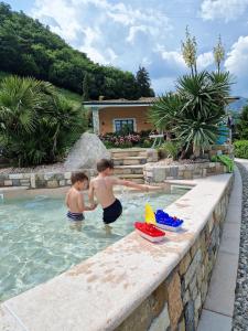 特雷莫西内特里公寓式酒店的两个男孩在游泳池玩耍