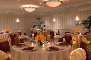 韦克菲尔德波士顿韦克菲尔德福朋喜来登酒店及会议中心的宴会厅配有桌椅和鲜花