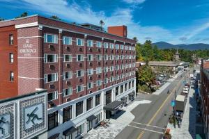 普莱西德湖Grand Adirondack Hotel, Lake Placid, a Tribute Portfolio Hotel的城市街道上一座大型红砖建筑