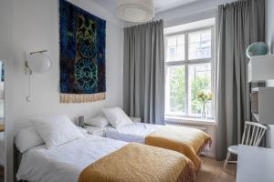 赫尔辛基Luxury Design Gem in City Center with Sauna and workspace的一间卧室设有两张床和窗户。