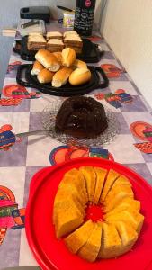 瓜拉派瑞Hope Hostel Guarapari的一张桌子,上面有蛋糕和面包盘