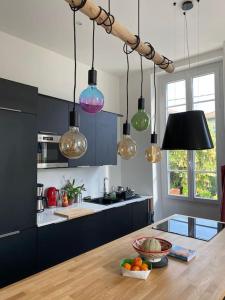 尼斯Petit Paradis的厨房配有一张桌子,放着一碗水果和灯