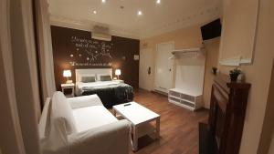 巴塞罗那佩蒂特普里塞普旅馆的一间卧室配有一张床和一个沙发