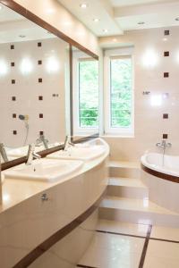 拉塔Ohana Space w Juracie的一间带三个盥洗盆、浴缸和楼梯的浴室