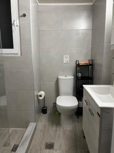罗德镇Popi's Place的浴室配有白色卫生间和盥洗盆。