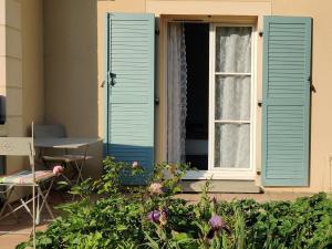 隆瑞莫Ocalm的鲜花房子上带蓝色百叶窗的窗户