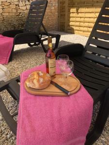 PuyréauxThe charming private Farmhouse at La Grenouillére的一瓶葡萄酒和一张桌子上的面包