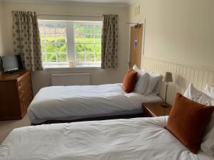 BallindallochThe Delnashaugh的酒店客房设有两张床和窗户。