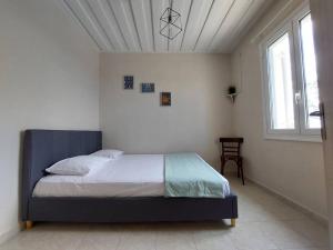 凯法利尼亚岛Giannata House的一间白色客房内的床铺卧室