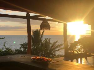 安迪拉纳Superbe villa avec ponton privé的坐在海洋前桌旁的碗食物