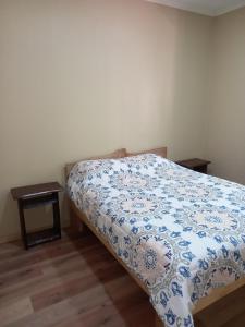 普孔El roble cabañas hualle的一间卧室配有一张带蓝色和白色棉被的床