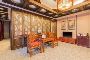 北京金龙建国温泉酒店的客厅配有木制家具和平面电视