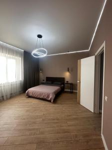 乌拉尔斯克Уютная квартира в центре города的一间卧室配有床和灯具