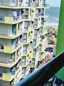 北马马亚-讷沃达里Beach Resort Studio Fitness-spa-pool的带阳台和大海的高楼