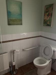 利特里姆Clinton’s cottage的一间带卫生间的浴室和墙上的绘画