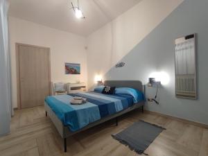 托雷拉皮罗SEA ROOM A TORRE LAPILLO - Guest House的一间卧室配有一张带蓝色毯子的床