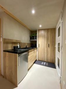 弗传斯LE COTTAGE Zen LOVE的一个带木制橱柜和水槽的厨房