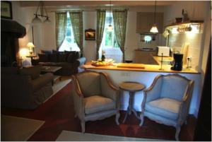 普瓦维莱特城堡酒店的客厅配有两把椅子和台面