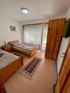阿尔贝纳Villa MAXIMILIYAN的一间卧室设有两张床和滑动玻璃门
