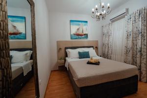 马卡尔斯卡Guesthouse Villa Diana的一间卧室配有一张床和镜子