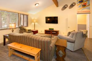 马姆莫斯湖豪斯假日酒店的客厅配有两张沙发和一台电视机