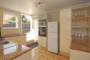 奥克兰2 Bed Apartment in Kingsland - FREE WIFI and parking的厨房配有白色冰箱和水槽