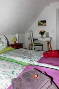 Ferienwohnung am Sachsenring的一间卧室配有一张床和一张桌子及椅子
