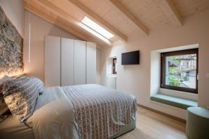 梅尔戈佐Ca Vincenza in Montorfano的一间卧室设有一张床和一个窗口