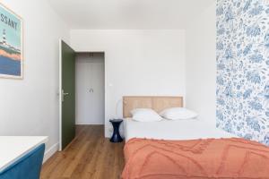 南特Joli Appartement avec Garage sur l'Île de Nantes的一间卧室配有一张带橙色毯子的床