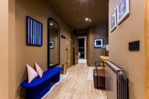 圣塞瓦斯蒂安ONDARRA Suite Apartment的走廊上设有蓝色长椅和枕头