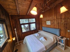 欧拉努波利斯Athos SEAgull wagon的木制客房内的一间卧室,配有一张床