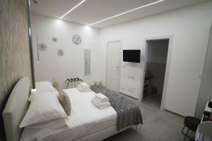 巴里Arco Alto Rooms的白色卧室,配有带毛巾的床
