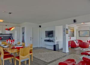 万根沃格WoogeQueen - 112 m² Luxus mit direktem Meerblick的用餐室以及带桌椅的起居室。