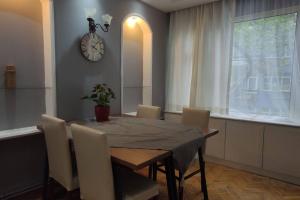 伊斯坦布尔Cozy Apt Nearby Beşiktaş - Keyif ve huzur dolu的餐桌、椅子和墙上的时钟