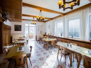 KlieningGasthof Wabitsch的餐厅设有木桌、椅子和窗户。