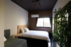 淡路Awaji Aqua Marine Resort Building No, 2 - Vacation STAY 09357v的一间卧室,配有床、窗户和植物